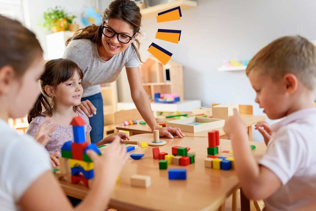 image of an adult with three children playing with blocks